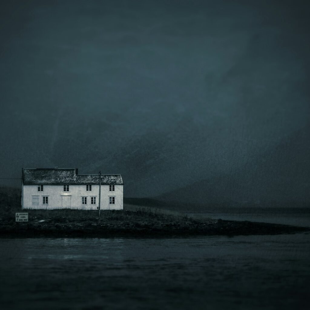 white concrete house beside shore